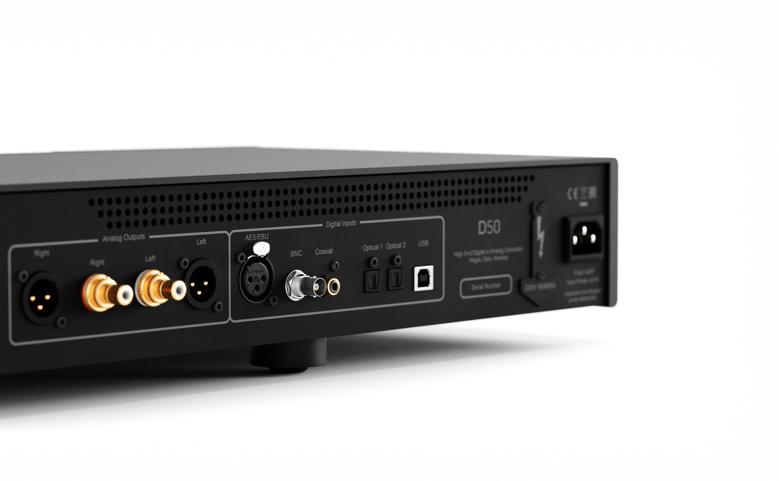Rear panel of audio equipment with multiple input connectors (XLR, RCA) and a power inlet, viewed from the side.